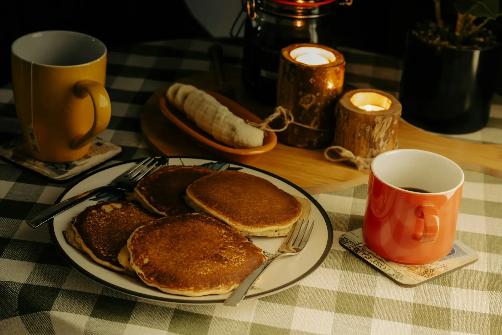 Pancakes and coffee on a checkered tablecloth
